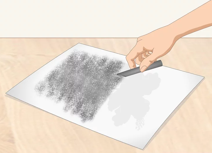 Use a soft charcoal stick to cover the back of the paper with charcoal wherever there are lines